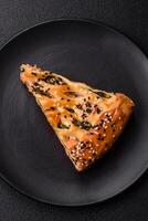 Pieces of quiche with salmon, spinach or broccoli, salt and spices photo