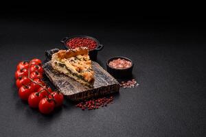 Pieces of quiche with salmon, spinach or broccoli, salt and spices photo