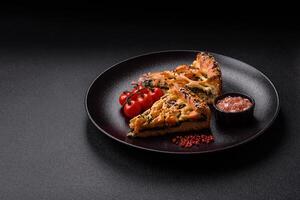 Pieces of quiche with salmon, spinach or broccoli, salt and spices photo