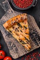 Pieces of quiche with salmon, spinach or broccoli, salt and spices photo