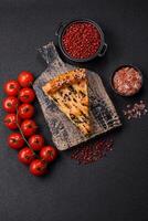 Pieces of quiche with salmon, spinach or broccoli, salt and spices photo