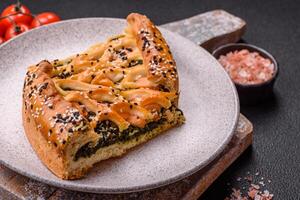 Pieces of quiche with salmon, spinach or broccoli, salt and spices photo