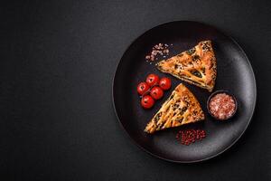 Pieces of quiche with salmon, spinach or broccoli, salt and spices photo