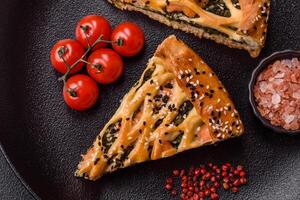 Pieces of quiche with salmon, spinach or broccoli, salt and spices photo