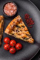 Pieces of quiche with salmon, spinach or broccoli, salt and spices photo