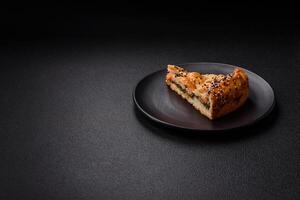 Pieces of quiche with salmon, spinach or broccoli, salt and spices photo