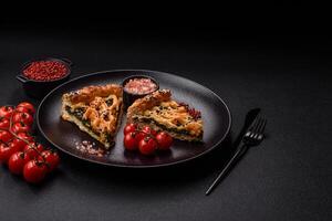 Pieces of quiche with salmon, spinach or broccoli, salt and spices photo
