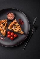 Pieces of quiche with salmon, spinach or broccoli, salt and spices photo