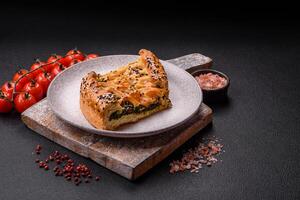 Pieces of quiche with salmon, spinach or broccoli, salt and spices photo