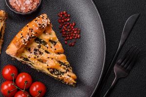 Pieces of quiche with salmon, spinach or broccoli, salt and spices photo