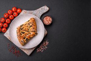 Pieces of quiche with salmon, spinach or broccoli, salt and spices photo