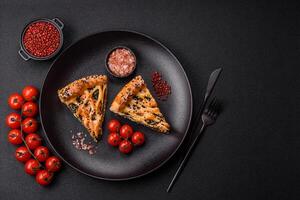 Pieces of quiche with salmon, spinach or broccoli, salt and spices photo