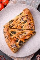 Pieces of quiche with salmon, spinach or broccoli, salt and spices photo
