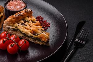 Pieces of quiche with salmon, spinach or broccoli, salt and spices photo