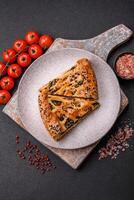 Pieces of quiche with salmon, spinach or broccoli, salt and spices photo