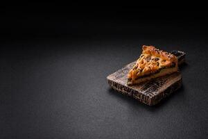 Pieces of quiche with salmon, spinach or broccoli, salt and spices photo