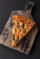 Pieces of quiche with salmon, spinach or broccoli, salt and spices photo