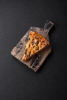 Pieces of quiche with salmon, spinach or broccoli, salt and spices photo