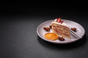 Piece of sweet layer cake with white cream, raspberries and strawberries photo