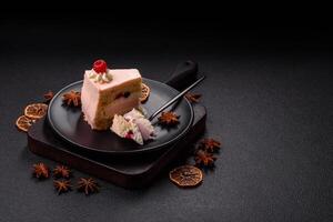 Piece of sweet cake with pink cream with raspberry flavor, with shortbread, cheesecake photo