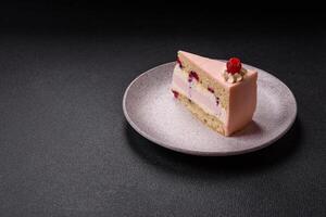 Piece of sweet cake with pink cream with raspberry flavor, with shortbread, cheesecake photo