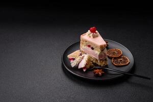 Piece of sweet cake with pink cream with raspberry flavor, with shortbread, cheesecake photo