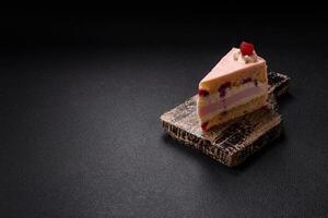 Piece of sweet cake with pink cream with raspberry flavor, with shortbread, cheesecake photo