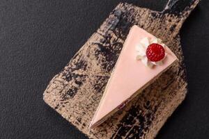 Piece of sweet cake with pink cream with raspberry flavor, with shortbread, cheesecake photo