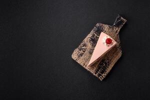 Piece of sweet cake with pink cream with raspberry flavor, with shortbread, cheesecake photo