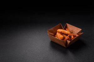Hot crispy shrimp breaded with salt and spices with white sauce photo