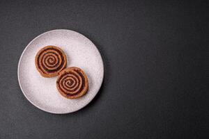 Freshly baked cinnamon roll with spices and cocoa filling photo