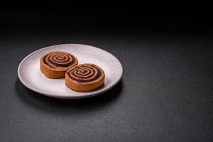 Freshly baked cinnamon roll with spices and cocoa filling photo
