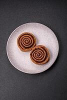 Freshly baked cinnamon roll with spices and cocoa filling photo
