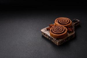Freshly baked cinnamon roll with spices and cocoa filling photo