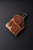 Freshly baked cinnamon roll with spices and cocoa filling photo