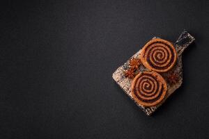 Freshly baked cinnamon roll with spices and cocoa filling photo