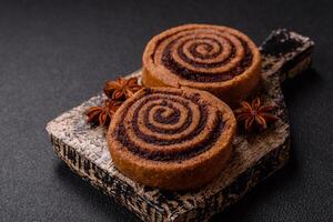 Freshly baked cinnamon roll with spices and cocoa filling photo