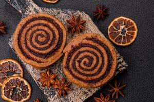 Freshly baked cinnamon roll with spices and cocoa filling photo