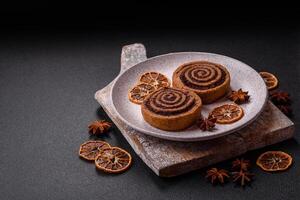 Freshly baked cinnamon roll with spices and cocoa filling photo