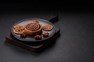 Freshly baked cinnamon roll with spices and cocoa filling photo