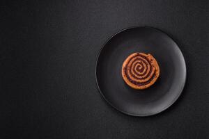 Freshly baked cinnamon roll with spices and cocoa filling photo