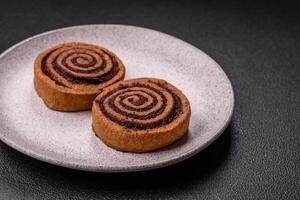 Freshly baked cinnamon roll with spices and cocoa filling photo