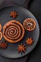 Freshly baked cinnamon roll with spices and cocoa filling photo