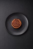 Freshly baked cinnamon roll with spices and cocoa filling photo