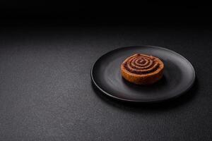 Freshly baked cinnamon roll with spices and cocoa filling photo