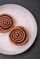 Freshly baked cinnamon roll with spices and cocoa filling photo
