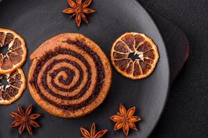 Freshly baked cinnamon roll with spices and cocoa filling photo