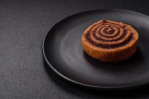 Freshly baked cinnamon roll with spices and cocoa filling photo
