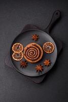 Freshly baked cinnamon roll with spices and cocoa filling photo