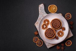 Freshly baked cinnamon roll with spices and cocoa filling photo